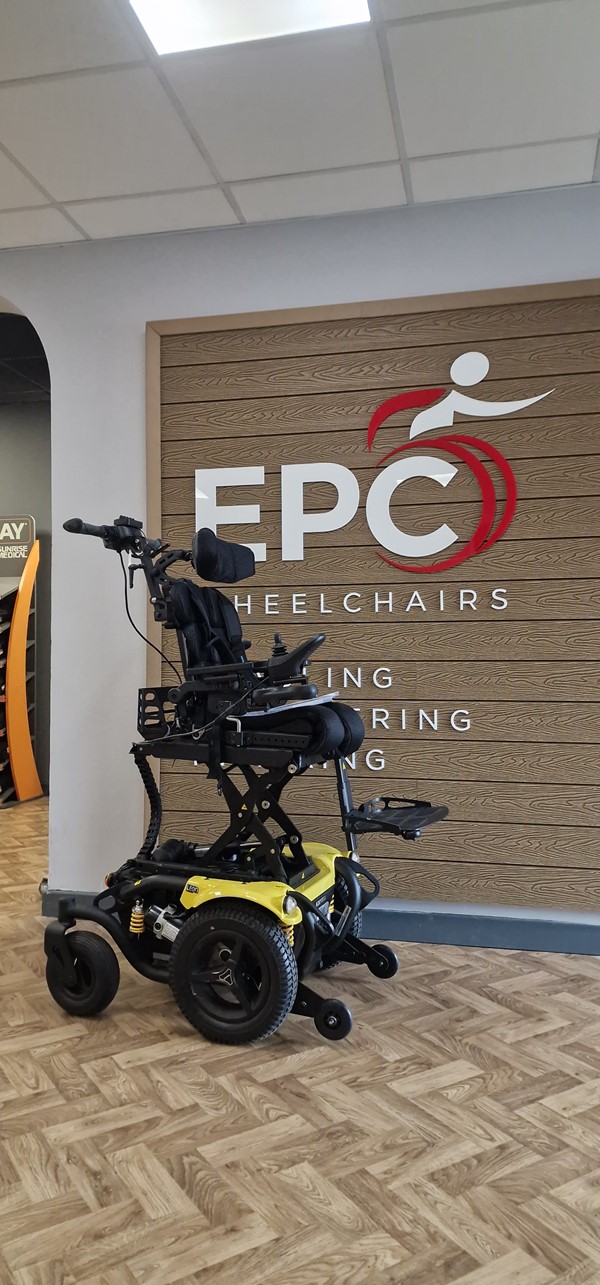 Image of a wheelchair in front of a sign