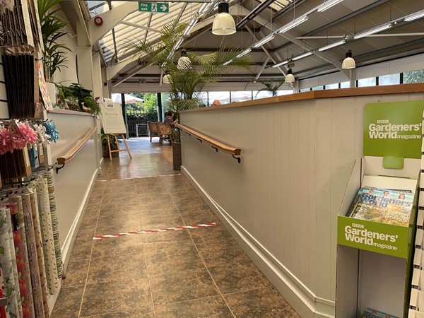 Image of a hallway with plants and a sign