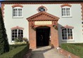 Image of a building with a door and a sign