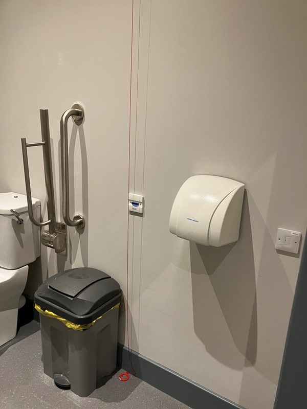 Another image of the accessible toilet showing the hand dryer.