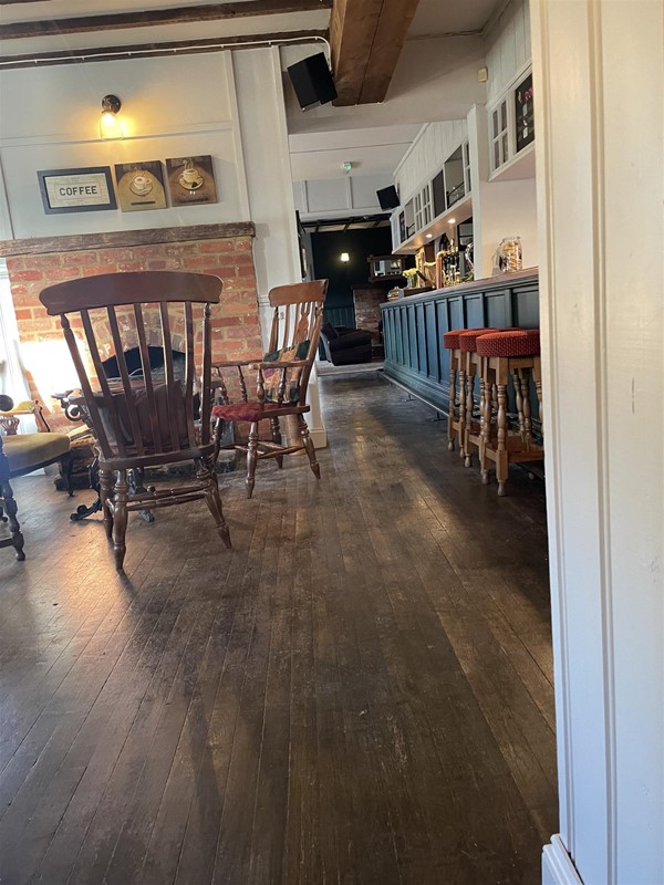 Image of chairs and tabled in a pub