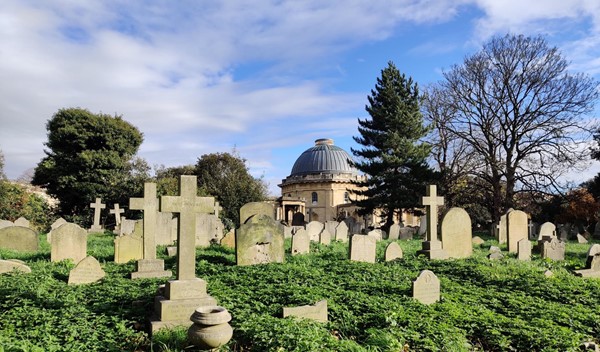 A view of the domed chapel across the gravestones of the cemetery.
