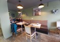 Image of a group of people sitting at tables in a restaurant