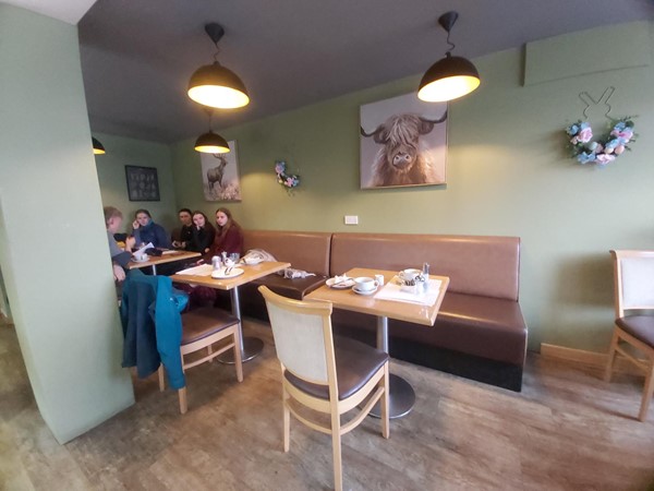 Image of a group of people sitting at tables in a restaurant