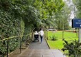 Heading for reception from rear accommodation.  Look at the angle on those hand rails…. My power chair was in danger of tipping backwards and I found tree roots across the path disconcerting.