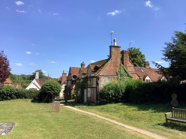 Picture of a red brick house in a graveyard