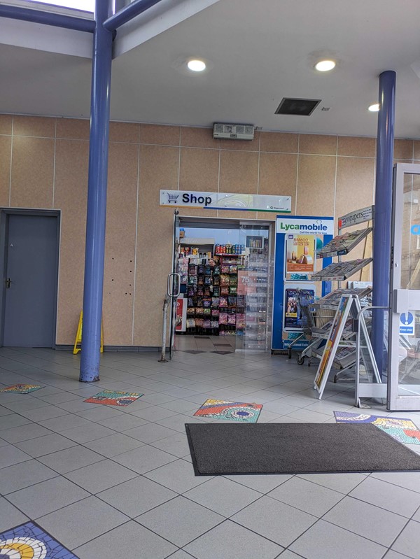 A store with a sign and a door