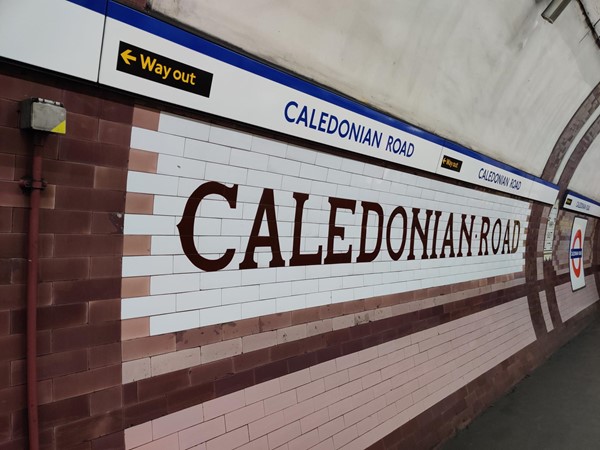 The platform wall with the station name spelt out in huge letters on the tiling.