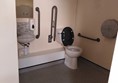 Image of a with a toilet with grabrails