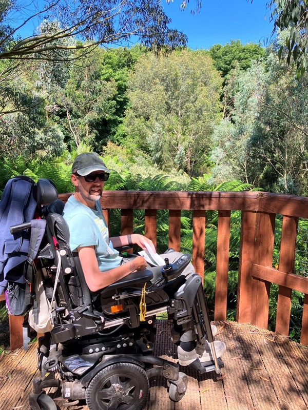 Powerchair user on a wooden platform