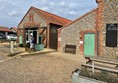 Toilet entrance with disabled parking space and cafe next door,