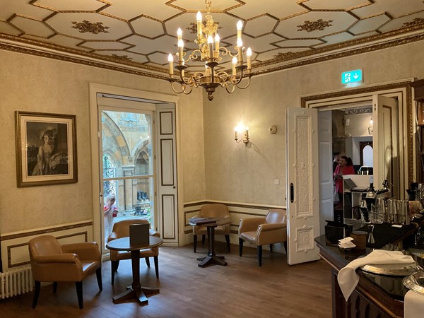 Image of a room with a chandelier and chairs