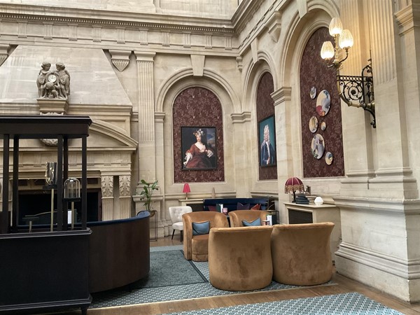 Image of a room with a large stone wall and a large table and chairs