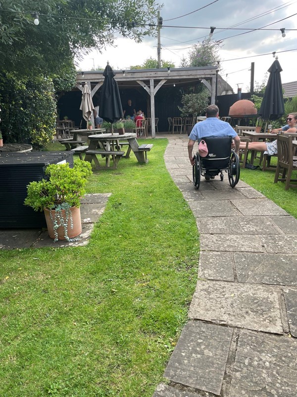 Image of a wheelchair user on a path