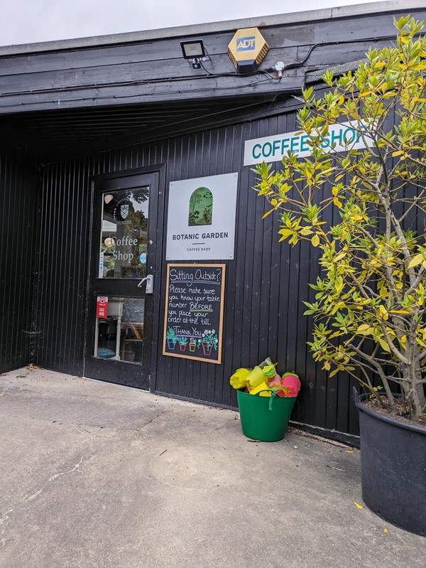 Image of a black building with a sign on the front