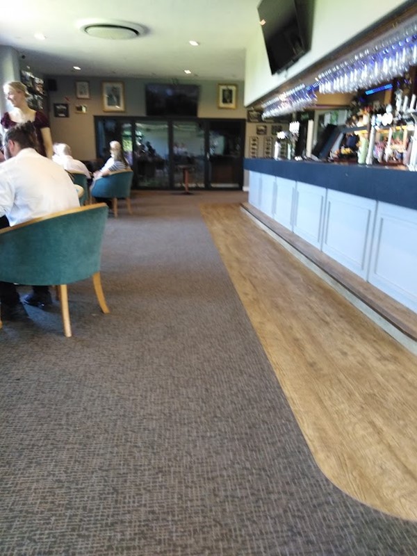 Image of a bar with people sitting at the counter