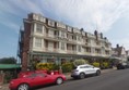 Image of a building with cars parked in front