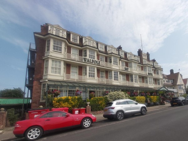 Image of a building with cars parked in front