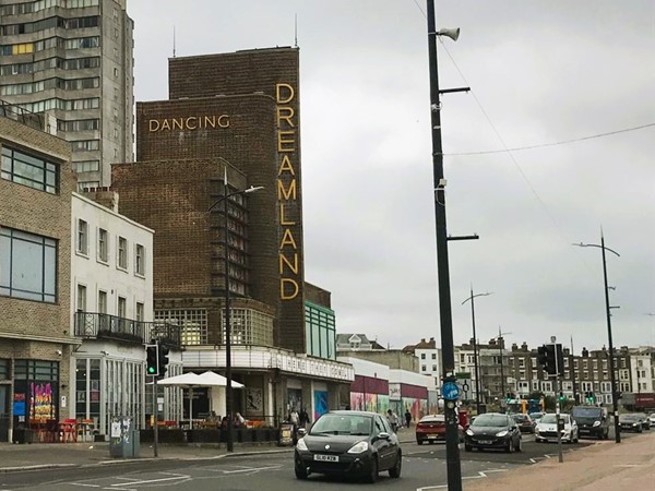 Image of a street with cars and buildings