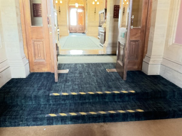 Image of a hallway with stairs leading to a building