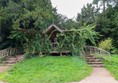 Japanese style summerhouse with steps going up to the entrance on both sides.