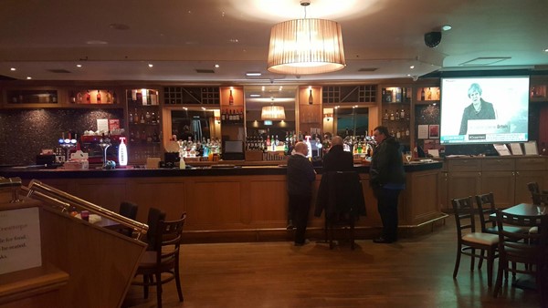 Bar with accessible tables on each side that are on the lower level.