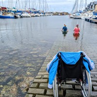 Using wheelchair to get to water's edge for a cold water swim