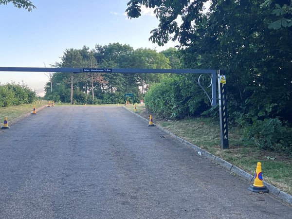 An open field car park with a 1.8m barrier (wheelchair accessible vehicles wouldn’t fit).