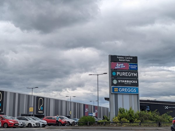 Image of an expansive shopping complex with vehicles parked outside