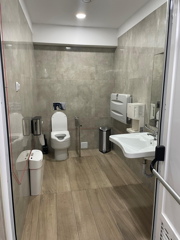 image of modern-looking disabled toilet with baby change table