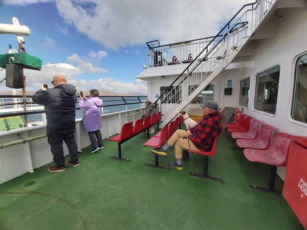 Image of a people on a boat with people on the deck