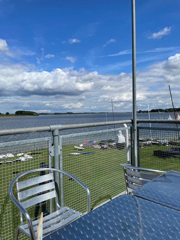 Metal chairs by a metal fence