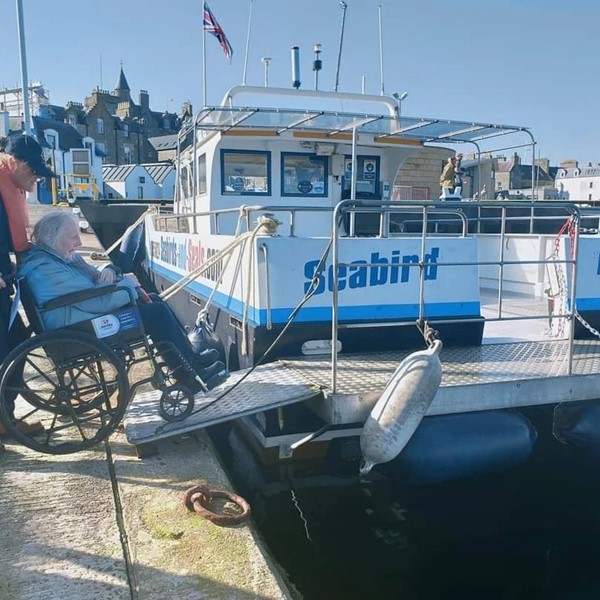 Boarding the boat, with help from Marie.