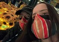 Picture of visitors in facemasks in front of sunflowers