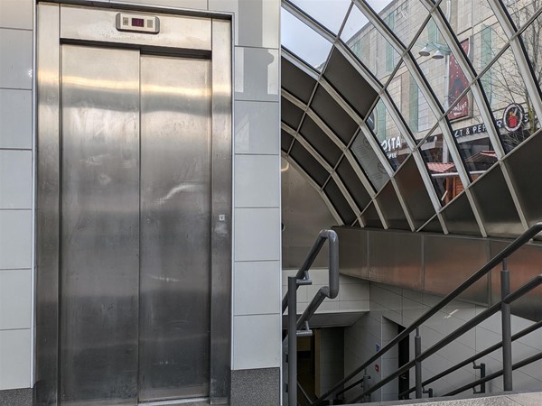 Image of lift entrance to St Enoch Subway Station and stairs with grab rails on both sides