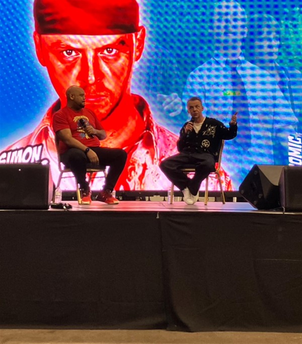 Image of two men sitting on a stage