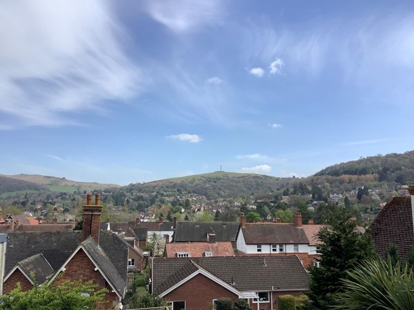 Picture of house roofs with a hilll in the background