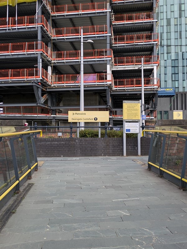 Image of the pathway to the tram station, building works are taking place in the distance