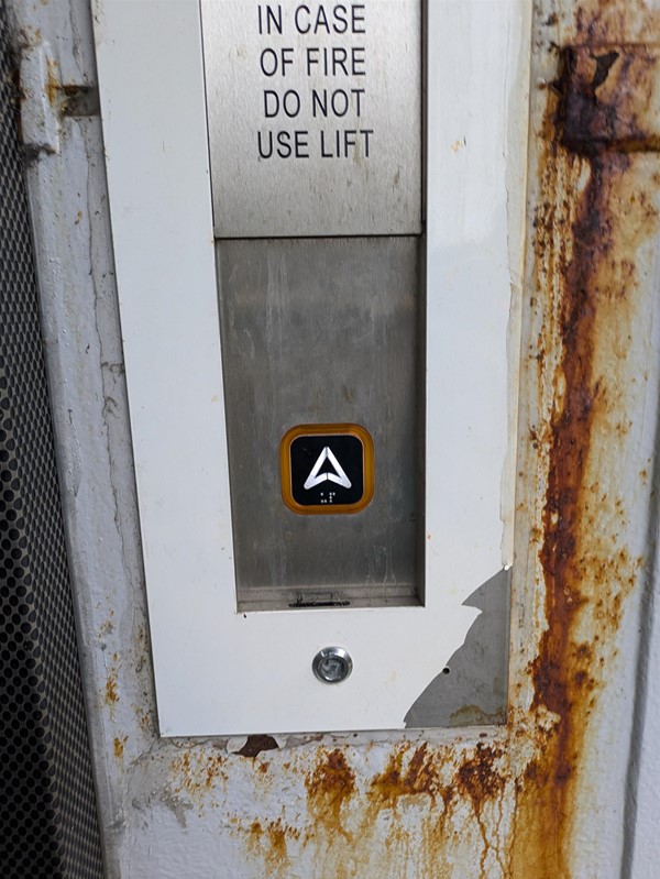 Image of lift button at Mount Florida Railway Station. The lift button has Braille Markings