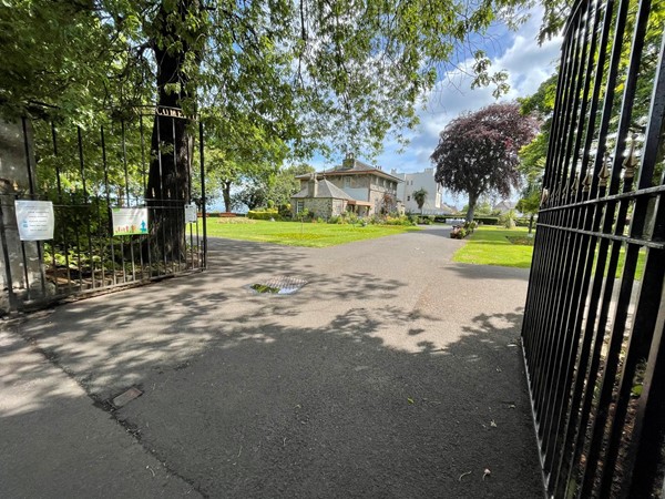 The main entrance to the park with its large iron gates.