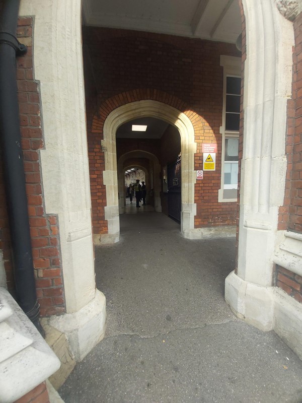 Image of an arch with a brick wall