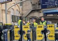 A group of people standing in front of a ticket gate