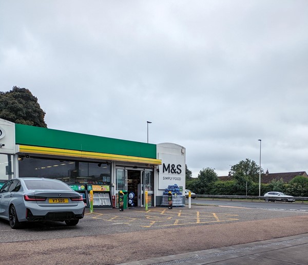 Image of a car parked outside of a petrol station