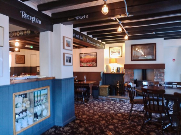 The inside of the pub/bar area, carpeted and with plenty of space.