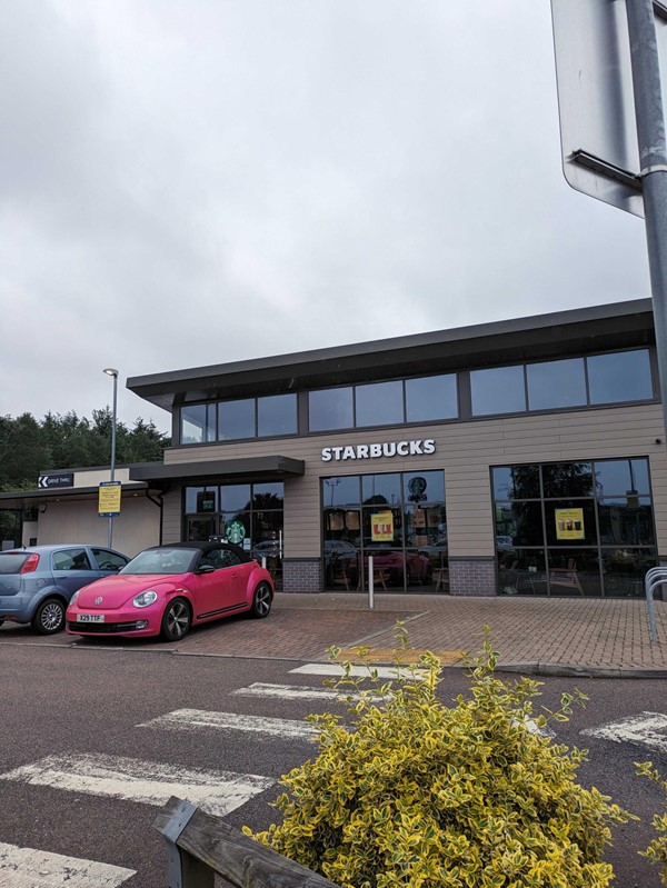 Image of a building with cars parked in front of it