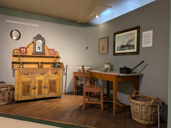 Image of a shelving unit and desk in a fisherman's cottage