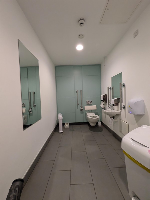 Image of the accessible toilet, a long room with a contrasting back wall