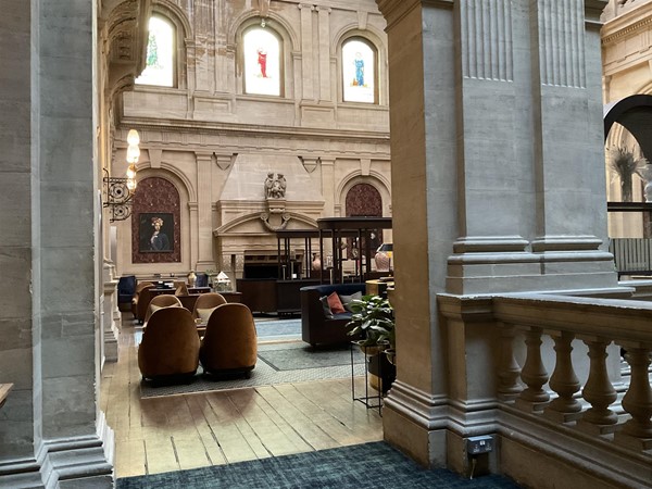 Image of a room with chairs and a stone wall