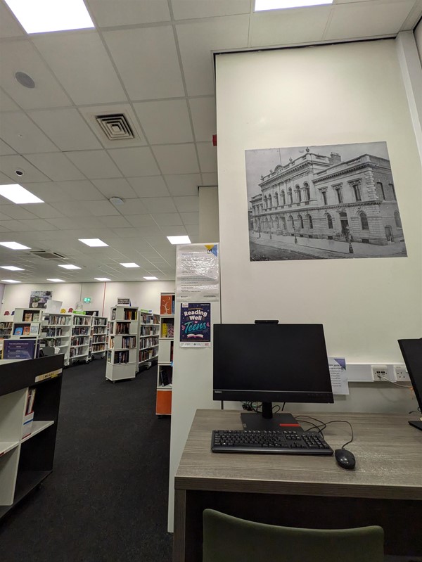 Image of library computers and shelves