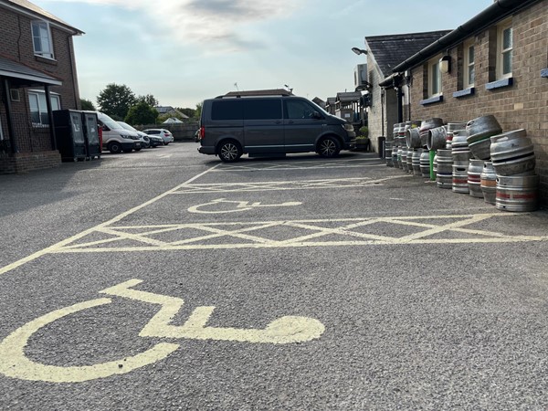 Image of a carpark with a wheelchair symbol painted on it